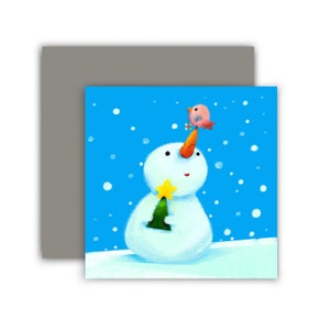 May include: A whimsical illustration of a snowman holding a Christmas tree and a star. A small bird sits atop the snowman's carrot nose. The background is a snowy blue with falling snowflakes. The image is on a square card.