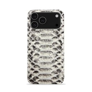 May include: A smartphone case featuring a snakeskin design in grey and white tones. The case incorporates a black camera module with three lenses and a flash. The pattern replicates the texture and look of snake scales.