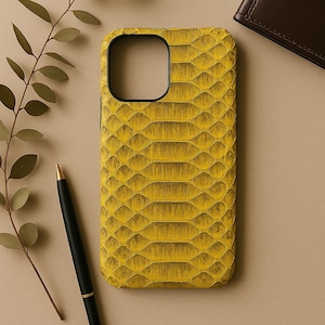 May include: A yellow snakeskin phone case with a black camera cutout.