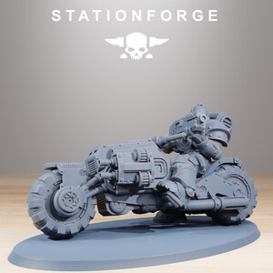 May include: A gray, futuristic motorcycle model with a rider in armor. The motorcycle has large, detailed wheels and a weapon mounted on the front. The text "STATIONFORGE" is at the top.