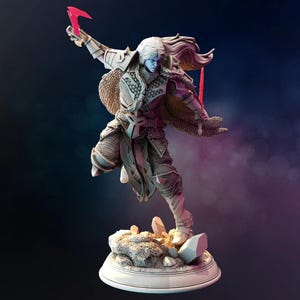 May include: A detailed figurine of a fantasy warrior with long white hair and blue skin, poised in a dynamic action pose. The warrior wears ornate armor and holds a red weapon. The figure stands on a rocky base with crystals, set against a dark background.