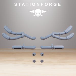 May include: A collection of light gray, 3D-printed mechanical components, including curved pipes, cylindrical pieces, and small circular parts. The word "STATIONFORGE" is printed at the top, along with a skull and crossbones logo. The parts are arranged on a wooden surface.