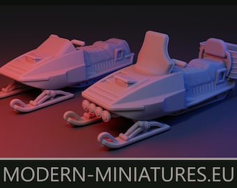 May include: Two unpainted gray miniature snowmobiles with detailed seats, handlebars, and front skis. The front snowmobile features four circular headlights, while the rear one has a storage rack. The text MODERN-MINIATURES.EU is at the bottom.