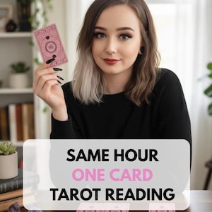 May include: A rectangular tarot card with a dusty pink background and intricate black line art patterns. The card features a central circular design with celestial symbols. The text SAME HOUR ONE CARD TAROT READING is displayed in black and pink.