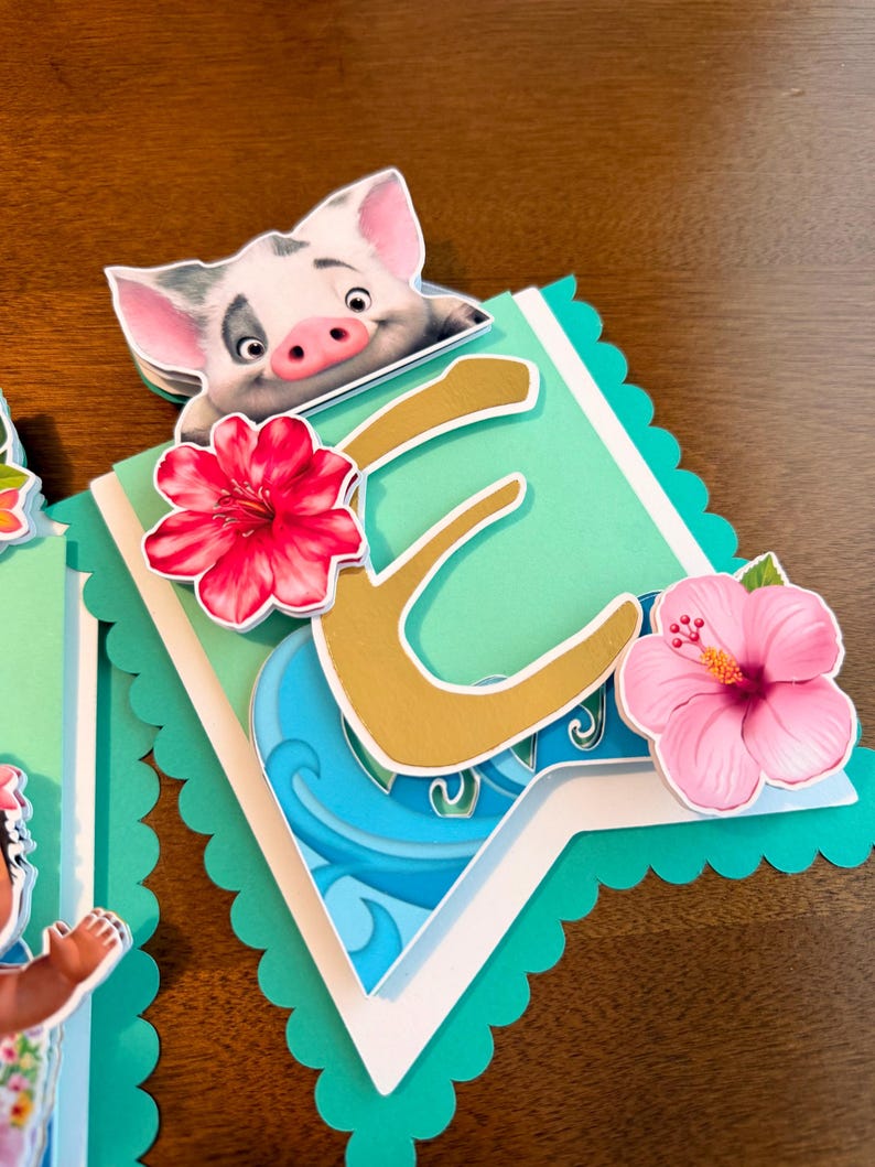 May include: A layered banner with a teal scalloped edge, featuring a gold letter "E", a cartoon pig, and pink and red hibiscus flowers. The banner has a tropical theme with blue wave details.