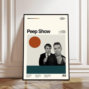 May include: A framed poster featuring the title "Peep Show" in bold black letters. The poster includes a photo of two men, a large orange circle, and a teal stripe at the bottom. The names of the cast and creators are listed.