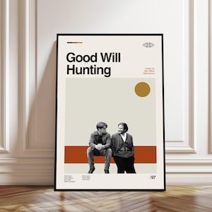 Op de afbeelding: Een ingelijste poster met de filmtitel "Good Will Hunting" in vette zwarte letters. De poster heeft een minimalistisch ontwerp met een beige achtergrond, een bruine streep en een gouden cirkel. Twee mannen zijn onder de titel afgebeeld. De poster hangt aan een witte muur.
