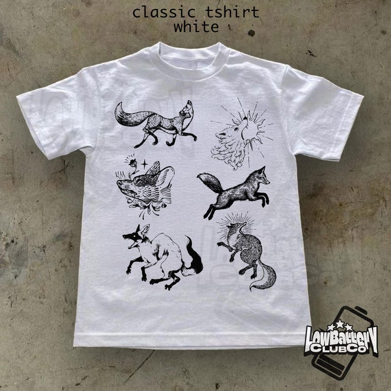 May include: White classic t-shirt featuring black illustrations of foxes in various poses. The shirt includes the text "classic tshirt white" at the top. A logo is visible in the bottom right corner.