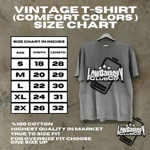 May include: Gray vintage t-shirt with the text "LowBattery CLUBCO" and a battery graphic. The size chart in inches is displayed, with measurements for sizes S to 2X. Made of 100% cotton.