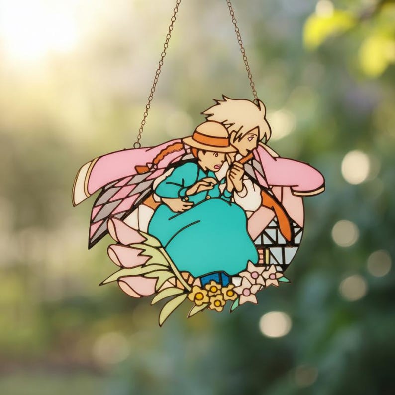 May include: A colorful stained glass window featuring a romantic anime scene. The artwork depicts a couple surrounded by flowers, with the man wearing a pink cape and the woman in a teal dress and straw hat. The window hangs from a chain.