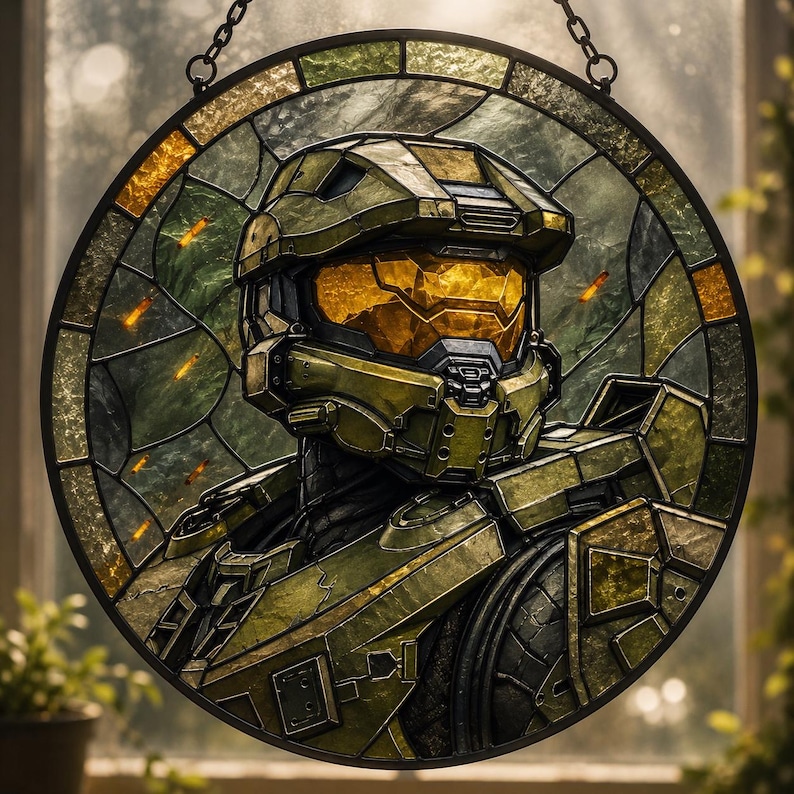 May include: Circular stained glass artwork depicting a futuristic soldier in olive green armour. The soldier's helmet has a gold visor. The glass is framed in a dark metal and hangs from a chain. The background shows a blurred outdoor scene.