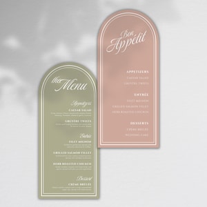 Peut inclure: Deux élégants cartons de menu avec des sommets arqués. L'un est vert sauge, l'autre est rose blush. La carte verte dit "the Menu" et répertorie les entrées, les plats et les desserts. La carte rose dit "Bon Appétit".