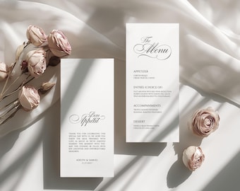 May include: Elegant wedding menu cards with floral accents. One card reads "The Menu" with a list of courses. The other card says "Bon Appétit" with a thank you message. Soft lighting and dried roses.