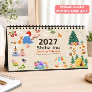 May include: A 2027 Shiba Inu desktop calendar with a spiral binding, featuring illustrations of Shiba Inu dogs in various seasonal settings, including Mount Fuji, a Christmas tree, a tent, and flowers, with the text 2027 Shiba Inu Desktop Calendar.