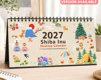 May include: A 2027 Shiba Inu desktop calendar with a spiral binding, featuring illustrations of Shiba Inu dogs in various seasonal settings, including Mount Fuji, a Christmas tree, a tent, and flowers, with the text 2027 Shiba Inu Desktop Calendar.