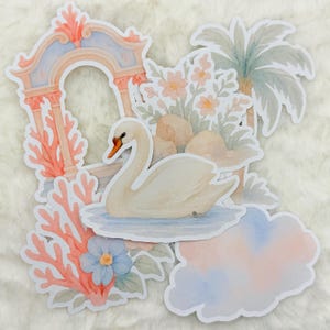 May include: A set of watercolor stickers featuring a white swan, a pink and blue cloud, a coral reef, a floral arrangement, and a blue and pink archway.