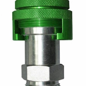 May include: A metal fitting with a green, textured cap and a silver body. The fitting has a hexagonal nut and threaded end. The green cap has a diamond pattern. The fitting is designed for connecting hoses or pipes.