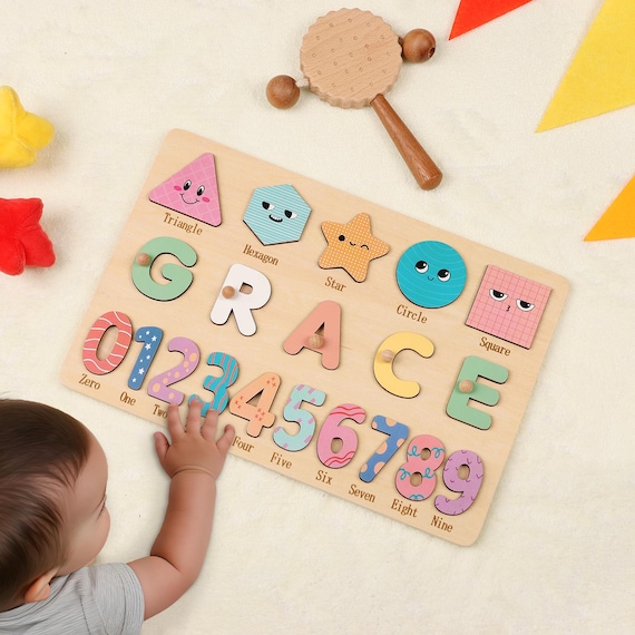 A custom wooden busy board puzzle where the child's name IS the toy — each letter becomes a tactile activity piece, doubling as nursery decor.