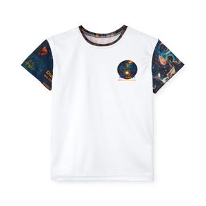 May include: White t-shirt with short sleeves featuring a colorful galaxy design on the sleeves and collar. The shirt has a circular graphic on the chest with the text "KIDSDO YOU KNOW?" and the words "#WEARETHEFUTUREOFEDUCATION".