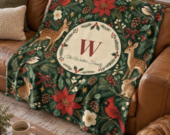 May include: A dark green throw blanket featuring a festive pattern of red poinsettias, pine cones, holly berries, deer, rabbits, and cardinals. A central cream-colored circular emblem displays the letter W and the text The Walker Family.