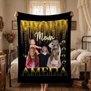 May include: Black blanket with a gold glitter design and the words "PROUD Mom 2026 AMELIA". The blanket features a photo collage of a woman in a graduation gown and several children. The blanket is held up by a person.