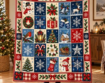 May include: A rectangular Christmas-themed throw blanket featuring a grid of festive illustrations including snowmen, snowflakes, a reindeer, a decorated tree, a lantern, a gift box, a bird, a stocking, and a cabin on a blue and red background.