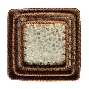 May include: Three square woven rattan trays nested together. The trays have a light brown color and a floral pattern on the inside. The trays are designed to be decorative and functional.