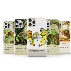 May include: Five different phone cases featuring illustrations of frogs from the book 'The Wind in the Willows' by Kenneth Grahame. The cases are white with a light beige background and feature different scenes from the book. The text on the cases includes quotes from the book.