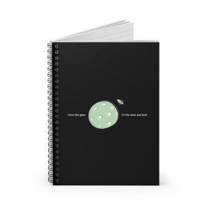 May include: Spiral-bound notebook with a black cover. The cover features a light green planet with white dots, a small rocket, and the text "I love this game" and "to the moon and back."