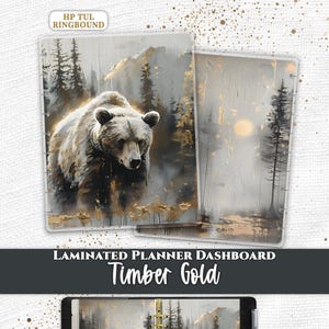 May include: Two laminated planner dashboards and one open planner featuring the Timber Gold design. The artwork displays a grizzly bear in a forest with gold accents, mountains, and trees. Text includes Everpage, HP TUL RINGBOUND, and LAMINATED PLANNER DASHBOARD Timber Gold.