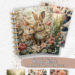 May include: Laminated planner cover with a floral and bunny design. The cover features two brown bunnies surrounded by flowers. The text "Meadow Kisses" and "Laminated Planner Cover" are visible. Additional cover designs include a forest scene, a dragonfly, and flowers.