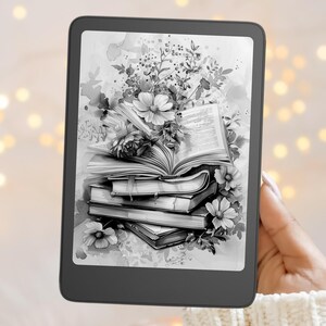 May include: A black e-reader device displaying a grayscale illustration of a stack of open and closed books adorned with detailed floral arrangements, including blooming flowers and leafy stems, set against a soft, light-colored background.