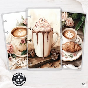 May include: A set of three laminated bookmarks featuring watercolor illustrations of coffee drinks, including a mug with whipped cream and chocolate drizzle, a latte with floral accents, and a cup of coffee served with a croissant on a floral plate.