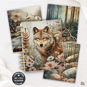 May include: A set of four laminated planner covers featuring nature-themed illustrations including a wolf surrounded by flowers, a forest with tall trees, a rocky landscape, and white flowers near a stream, all bound with gold-colored plastic discs.