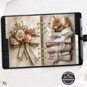 May include: A black ring-bound planner featuring two pages with illustrations of beige and white bows, a floral bouquet, and vintage-style paper textures. A silver pen is attached to the side, and a circular label reads Printable HP + TUL Ringbound Dashboard.
