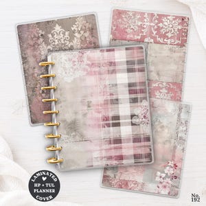 May include: A set of laminated planner covers featuring various designs in shades of pink, gray, and white. The covers display patterns including damask, plaid, and floral motifs, with gold-colored disc-binding rings visible on the central planner cover.