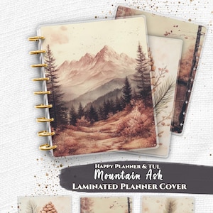 May include: A set of laminated planner covers for Happy Planner and TUL systems featuring Mountain Ash designs. The covers display watercolor-style illustrations of mountain landscapes, pine cones, and forest scenes in sepia and brown tones.