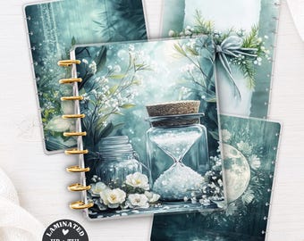 May include: A set of laminated HP and TUL planner covers featuring teal and white botanical illustrations, an hourglass, and a moon. The covers have gold-colored disc binding rings and display the text LAMINATED HP + TUL PLANNER COVER and No. 324.