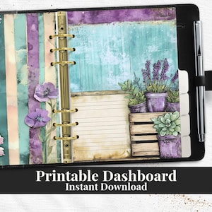 May include: A black planner with a floral design and the text "Printable Dashboard Instant Download". The planner features a gold binder, lined paper, and a pen. The design includes purple flowers and potted plants.