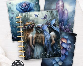 May include: A set of laminated planner covers featuring fantasy illustrations of three figures with floral crowns and blue wings, a large blue rose, purple crystals, and blue leaves. The covers have gold disc-bound rings and text reading Laminated HP + TUL Planner Cover.