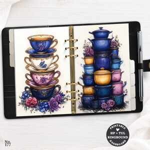May include: A black six-ring binder containing a printable dashboard with illustrations of stacked teacups and pots. The left page shows four stacked teacups with floral patterns, while the right page displays a pyramid of blue and yellow pots.