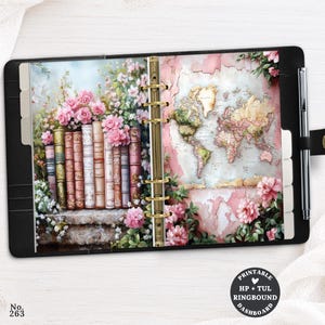 May include: A black ring-bound planner featuring a printable dashboard with a row of vintage books and pink flowers on the left page, and a world map with floral accents on the right page. A silver pen is attached to the side of the planner.