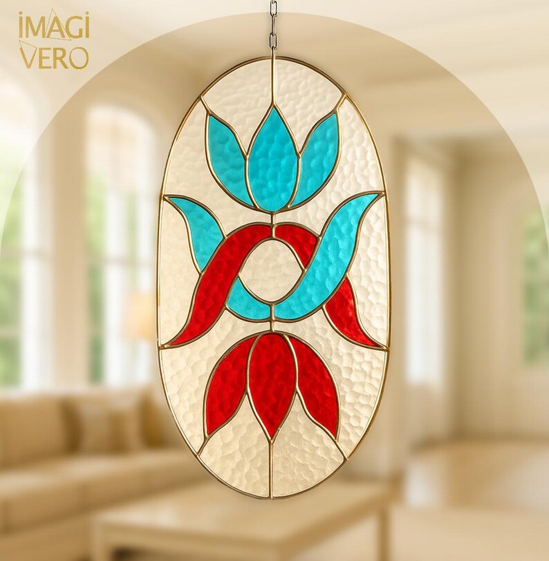 May include: An oval stained glass window featuring a floral design in red and turquoise against a textured white backdrop. The window is framed in gold and suspended by a chain. The text "IMAGI VERO" is in the upper left corner.