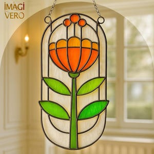 May include: A stained glass window panel depicting a stylized orange and yellow flower with green leaves and stem. The panel is framed in black metal and suspended by a chain. The logo "IMAGI VERO" is in the upper left corner.
