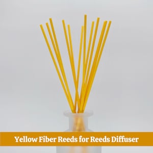 May include: A collection of bright yellow fiber reeds for a reed diffuser, arranged in a frosted glass bottle. The reeds are straight and slender, creating a visually appealing display. The text at the bottom reads "Yellow Fiber Reeds for Reeds Diffuser."