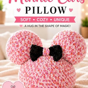 May include: A handmade Minnie Mouse ear pillow in pink, white, and orange yarn with a black bow. The pillow is soft and cosy, with the words "Minnie Ears Pillow" in pink. The text "Handmade with Love" is also visible.