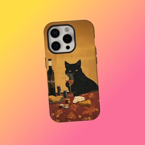 May include: A phone case featuring a black cat enjoying wine and cheese. The cat is depicted with a glass of red wine, sitting at a table with a bottle of wine, cheese, and poker chips. The background is a warm, golden hue.