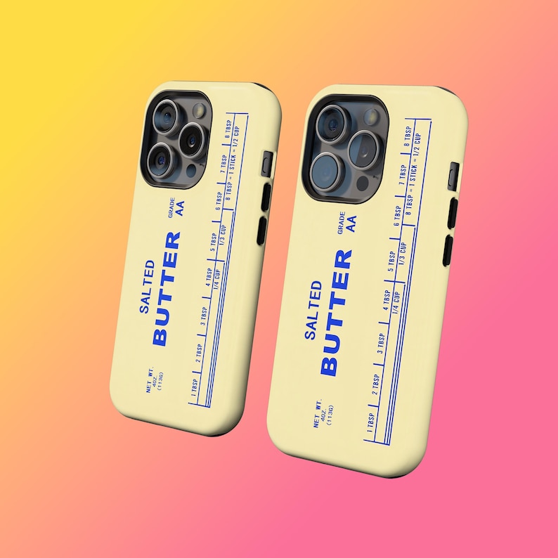 May include: Two phone cases with a butter-themed design. The cases are light yellow with blue text that reads "SALTED BUTTER" and a measurement chart. The cases have a black camera and button details.