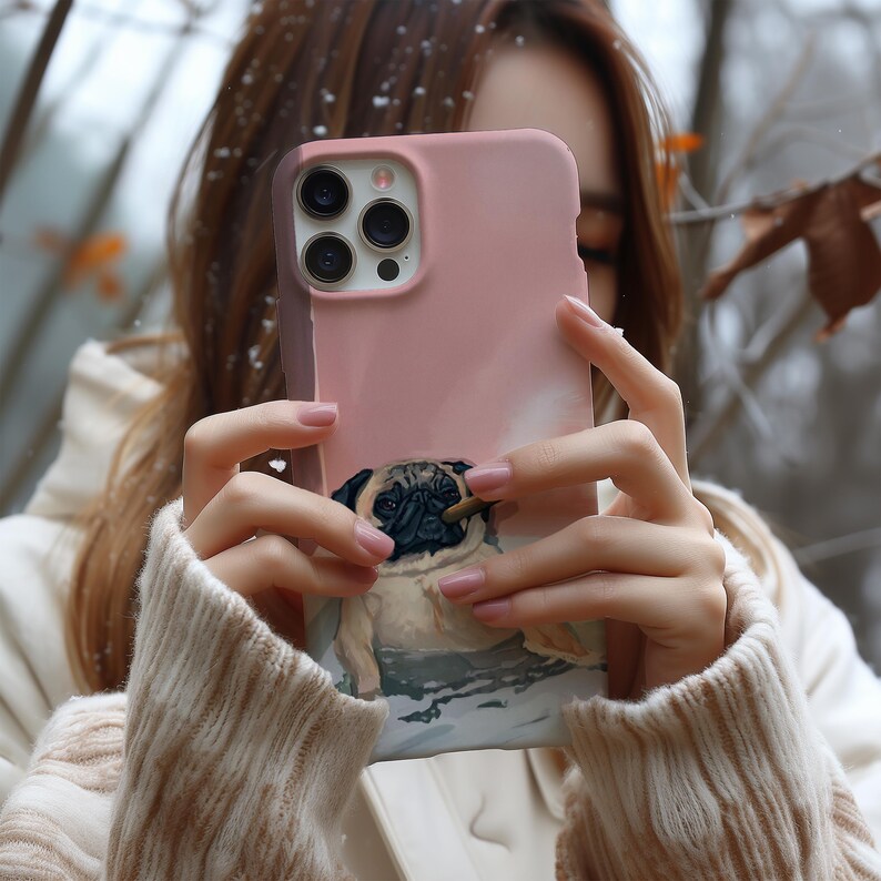 May include: A pink phone case featuring a pug dog design. The case has a smooth finish and a detailed illustration of a pug with a cigar. The phone case has a camera cutout and button placements.