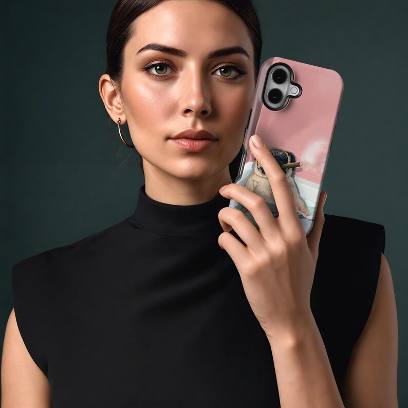 May include: A pink phone case featuring a penguin smoking a cigar. The case has a clear border and a light pink background. The penguin is depicted in a relaxed pose, with a cigar in its beak. The phone case is held by a person.